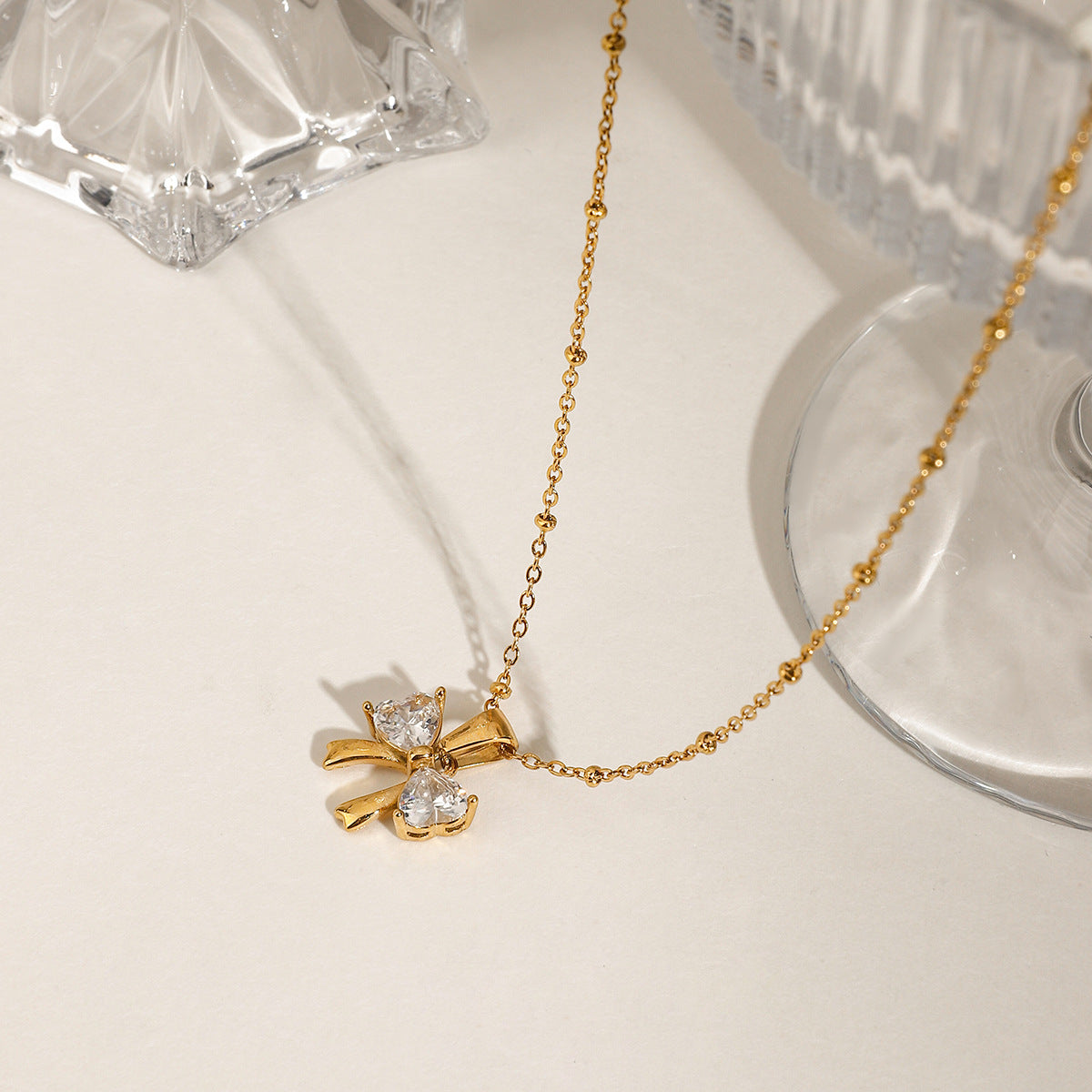 Elegant design with a fashionable and versatile 18k gold stainless steel bow, white zircon pendant necklace