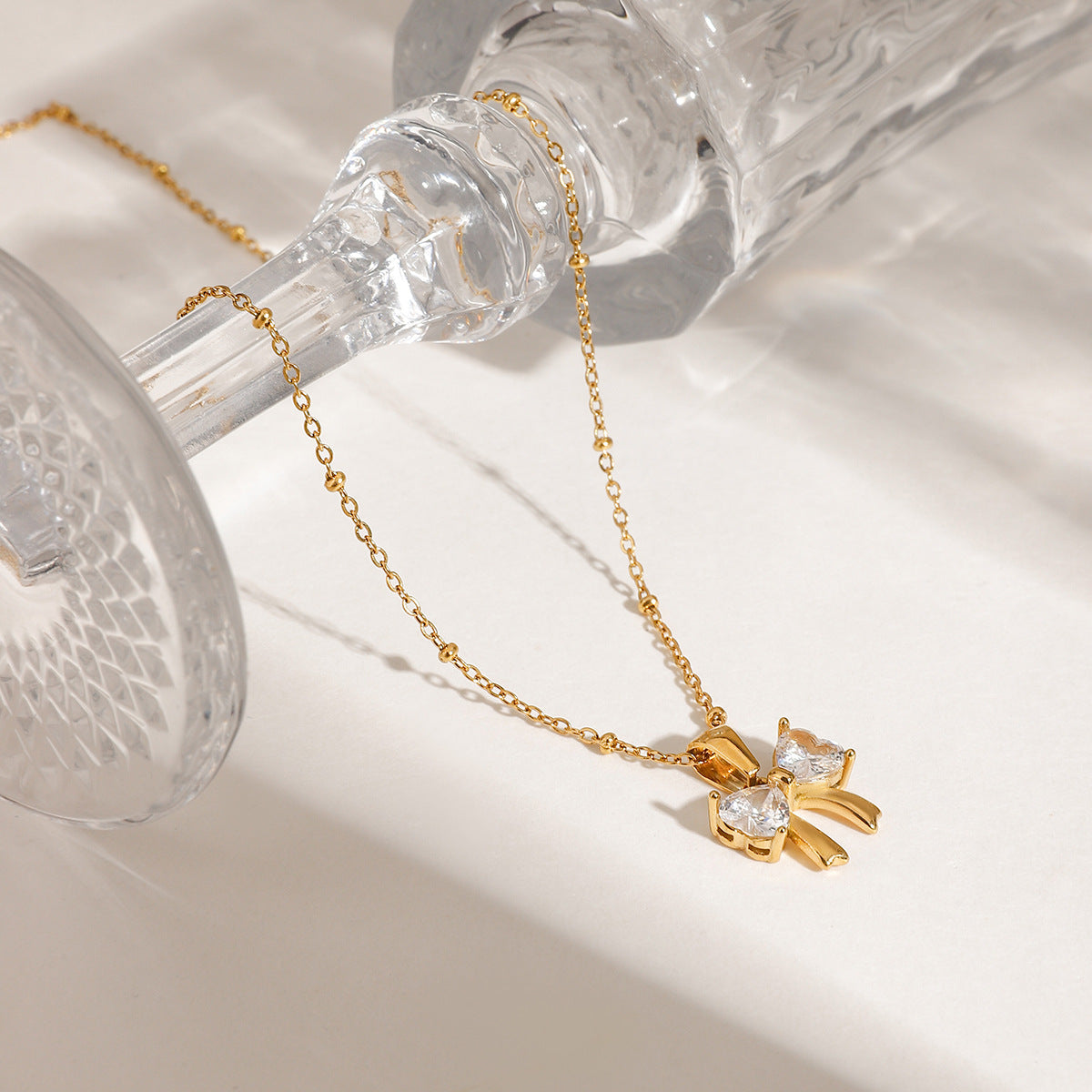 Elegant design with a fashionable and versatile 18k gold stainless steel bow, white zircon pendant necklace